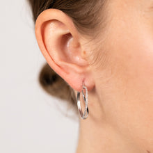 Load image into Gallery viewer, 1/10 Carat Diamond Crossover Hoop Earrings in Sterling Silver